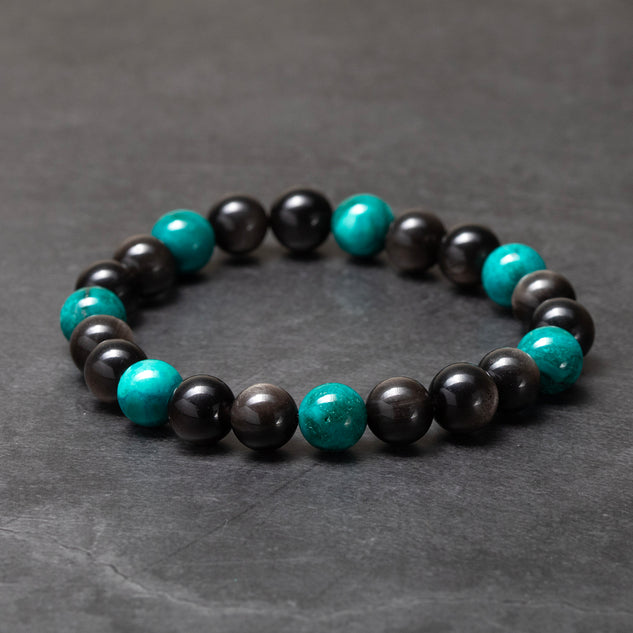 Bracelet with black and turquoise beads on a dark gray background