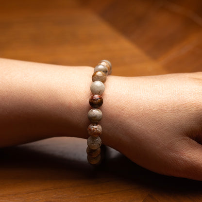 Beaded bracelet on a wrist with a wooden background
