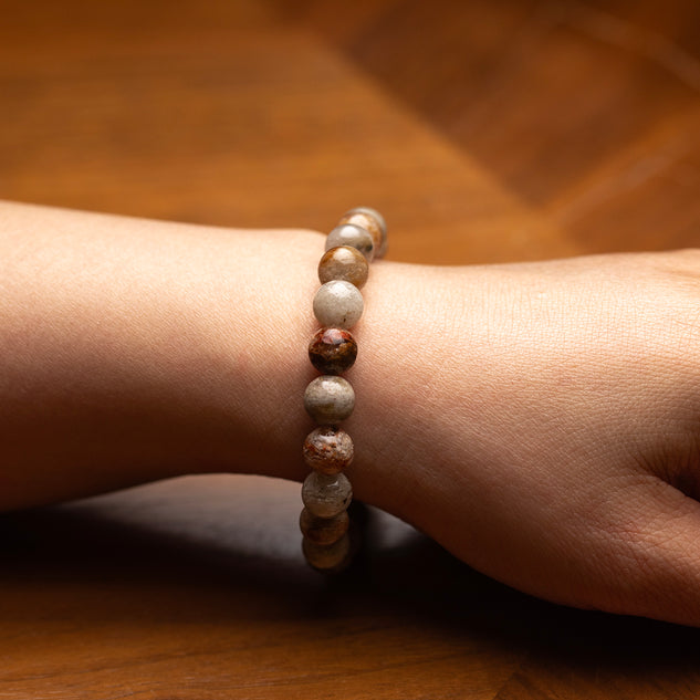 Beaded bracelet on a wrist with a wooden background
