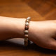 Beaded bracelet on a wrist with a wooden background