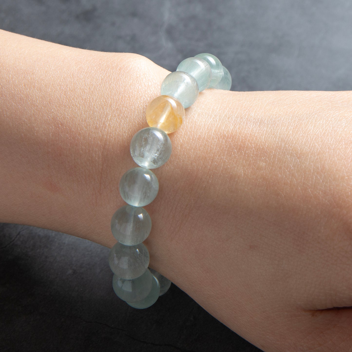 pale green beaded bracelet worn on a wrist