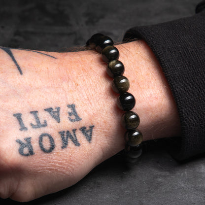 black bracelt on a tattooed hand of a man