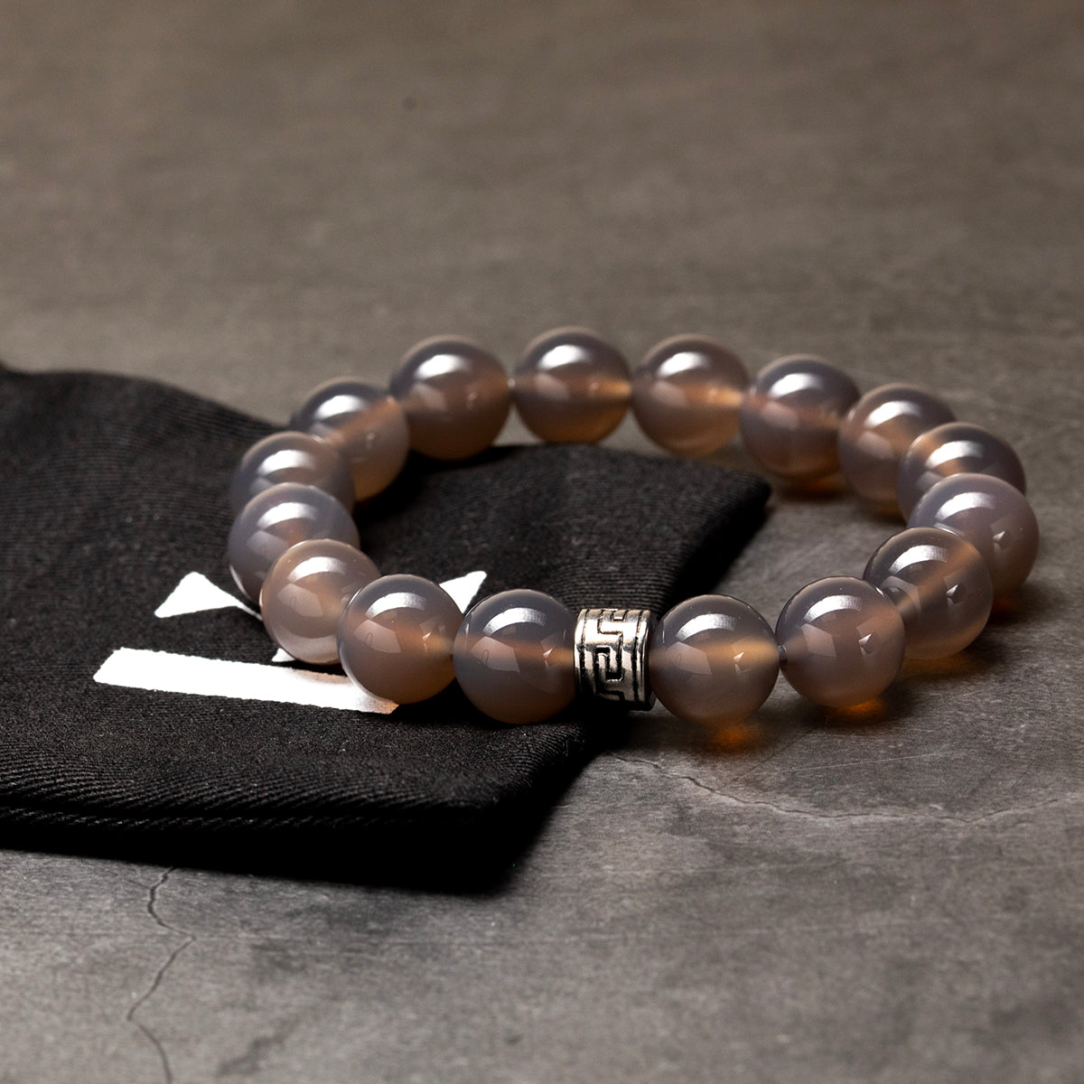 Pearl bracelet with a silver clasp on a dark surface