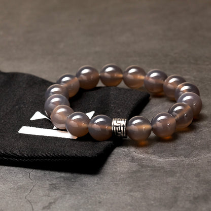 Pearl bracelet with a silver clasp on a dark surface