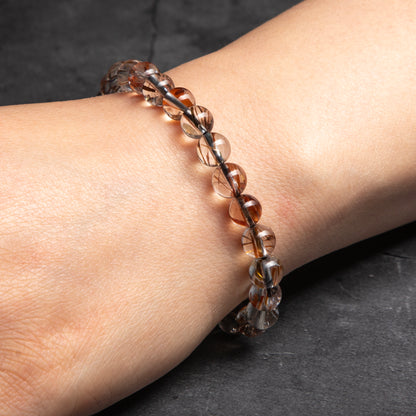 Beaded bracelet on a wrist against a dark background