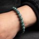 green beaded bracelet worn on the wrist