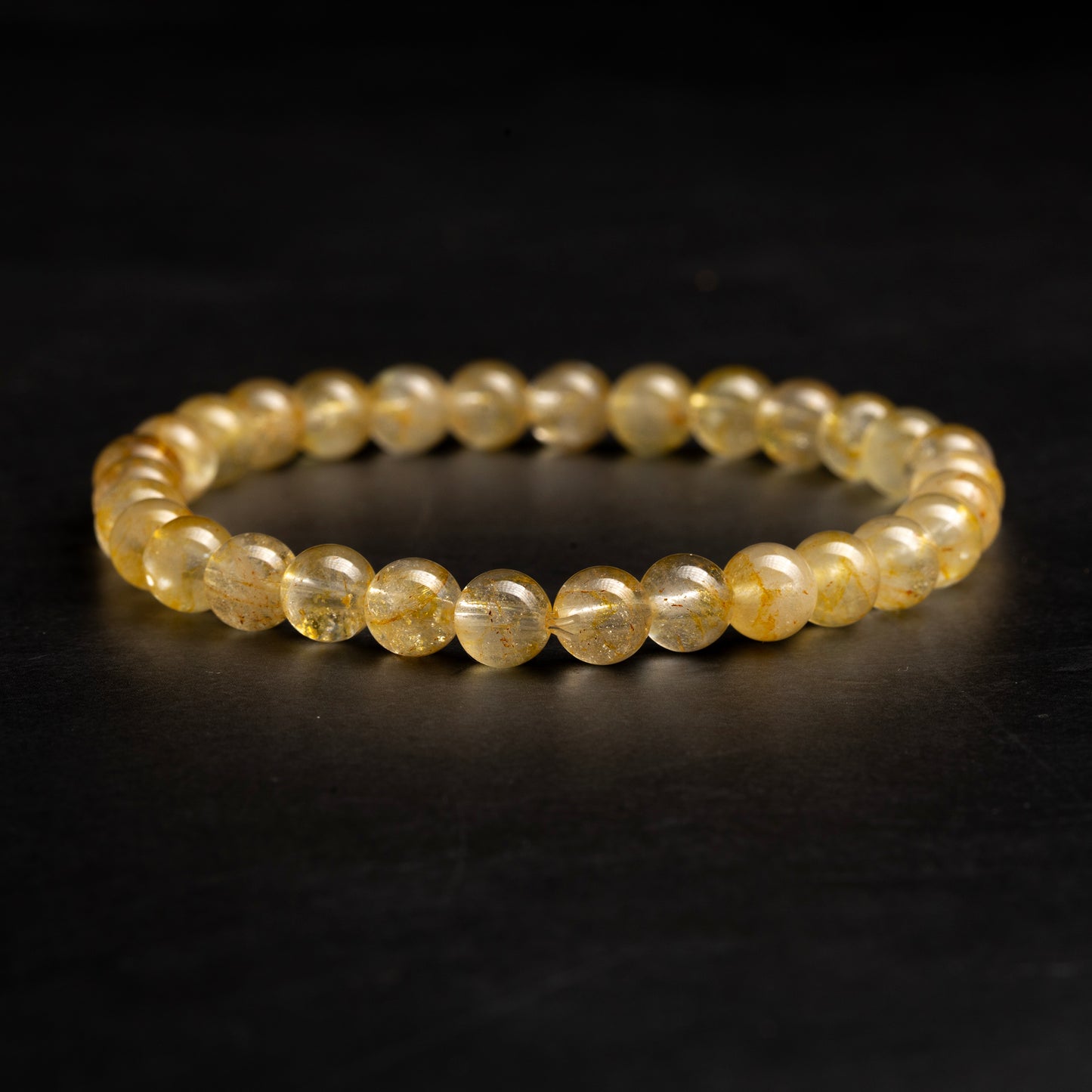 yellow bracelet on a dark background