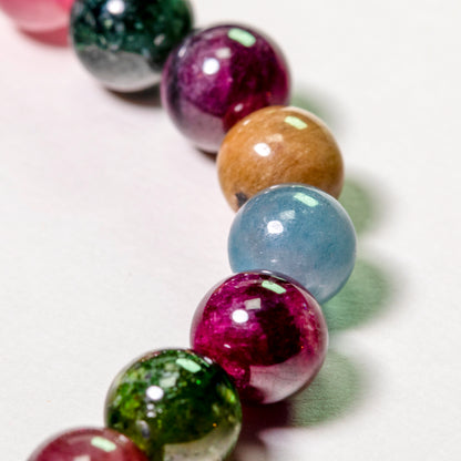 Close-up of a bracelet with multicolored beads on a white background
