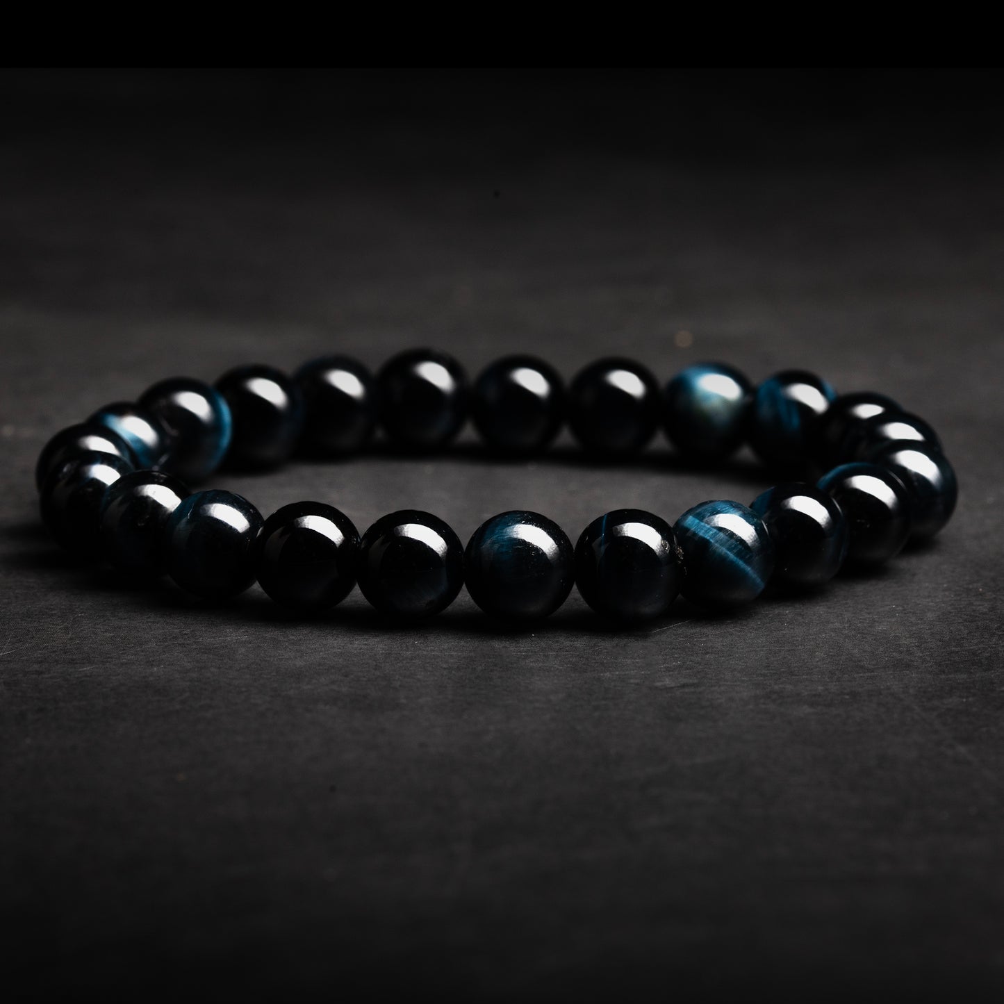 Black beaded bracelet on a dark background