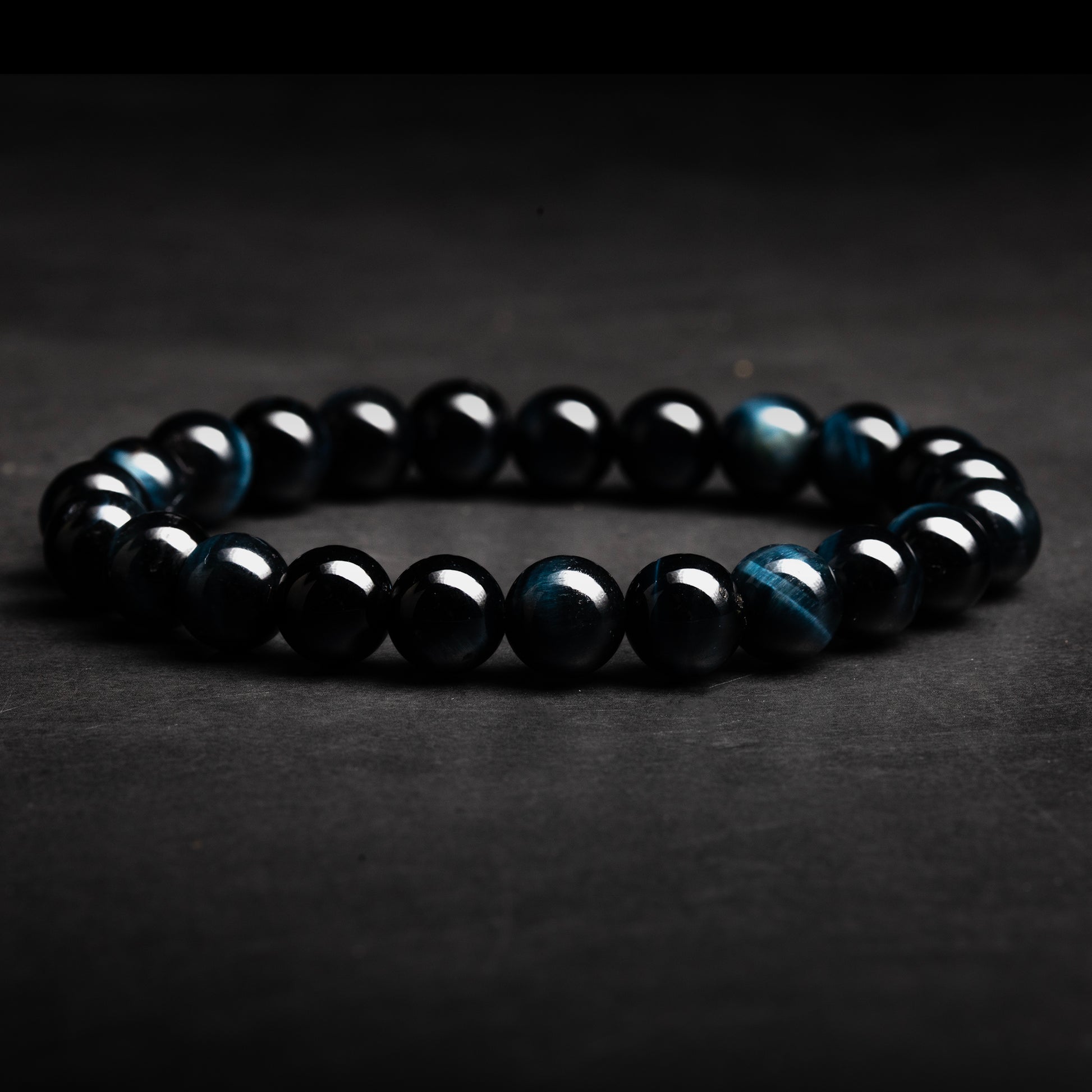 Black beaded bracelet on a dark background