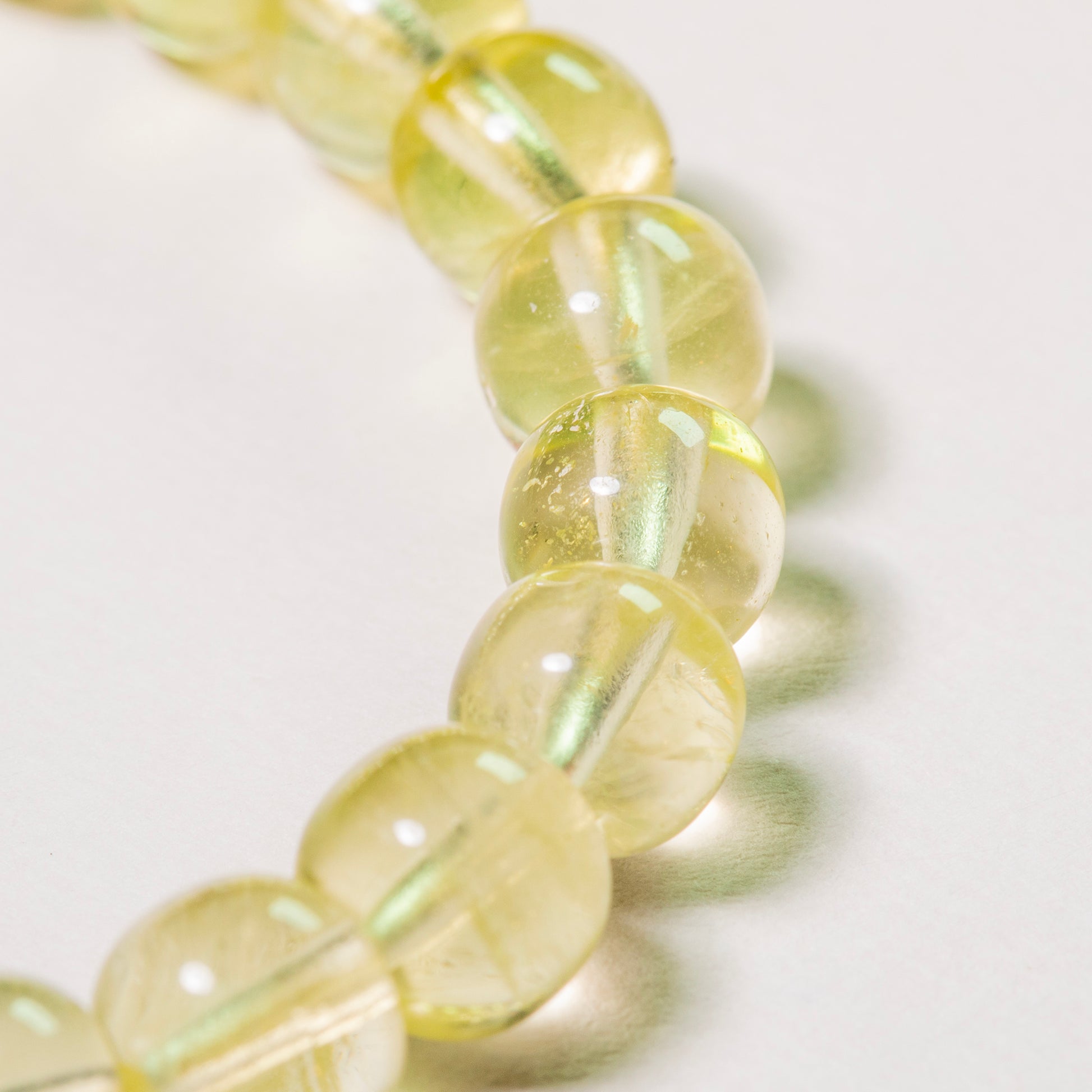 Close-up of a string of yellow beads on a white background