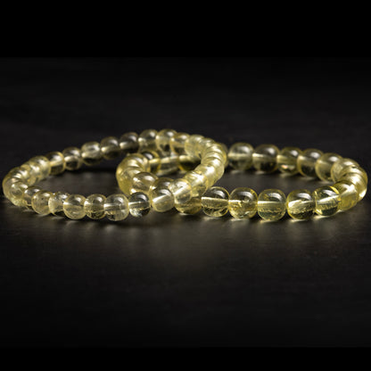 Two transparent beaded bracelets on a dark background