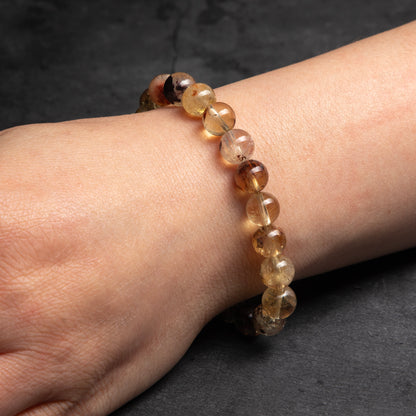 Beaded bracelet on a wrist against a dark background