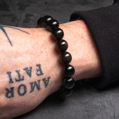 black bracelet worn on a man's wrist