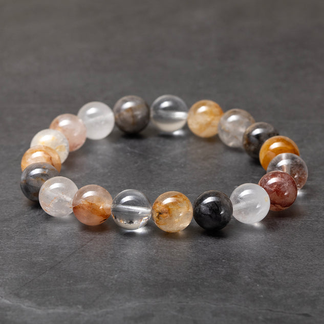 Multicolored beaded bracelet on a dark gray surface