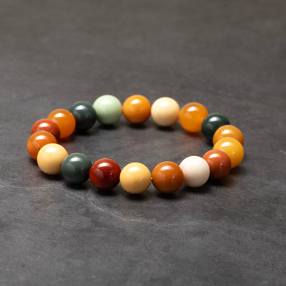Multicolored beaded bracelet on a dark gray background