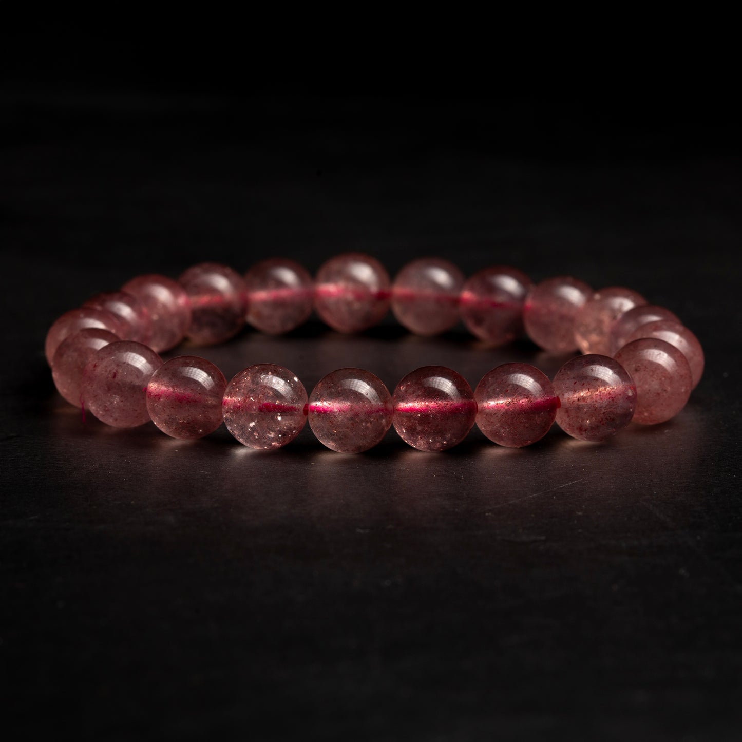 Pink beaded bracelet on a dark background