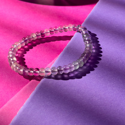 Beaded bracelet on a pink and purple fabric background