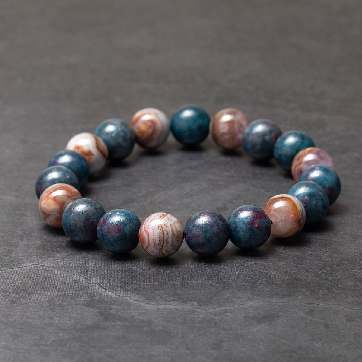 Marbled stone bracelet on a dark gray background