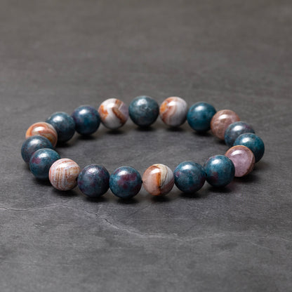 Marbled stone bead bracelet on a dark gray surface