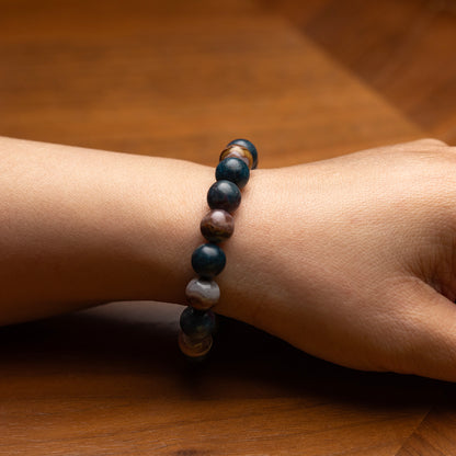 Beaded bracelet on a wrist against a wooden background