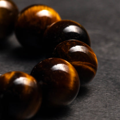 close up of a tiger eye bracelet on a dark background