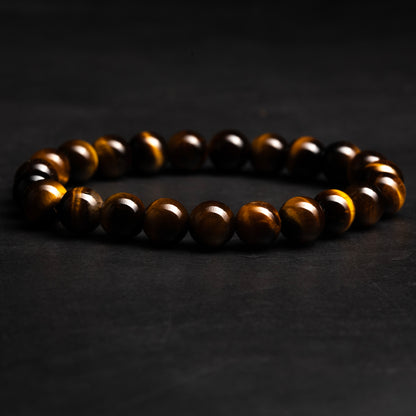 Brown beaded tiger eye bracelet on a dark background